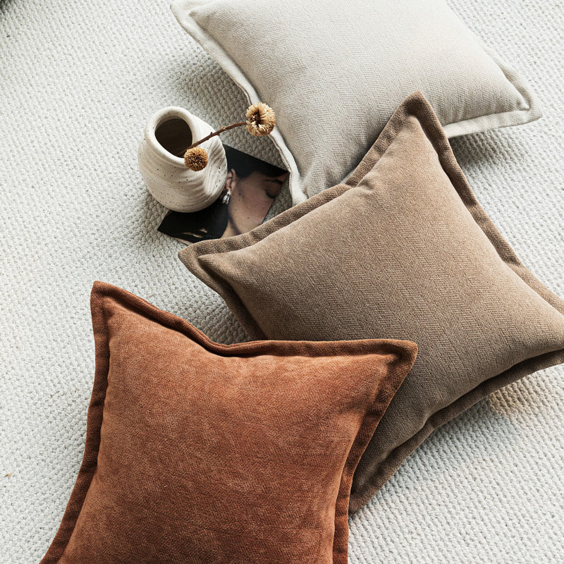 Chenille throw pillow covers in earthy tones on a sofa